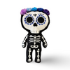 12 inch tall day of the dead skeleton plush with purple blue custom face printing 5 colorful flowers in shades of blues and purples satin lace flower halo and in  black minky white embroidery beautiful embroidery high quality plush halloween skeleton bat plushie halloween goth home decor childrens halloween dia de lost muertos skeleton plush day of the dead plush skeleton plush toy colorful sugar skull plush unique gift