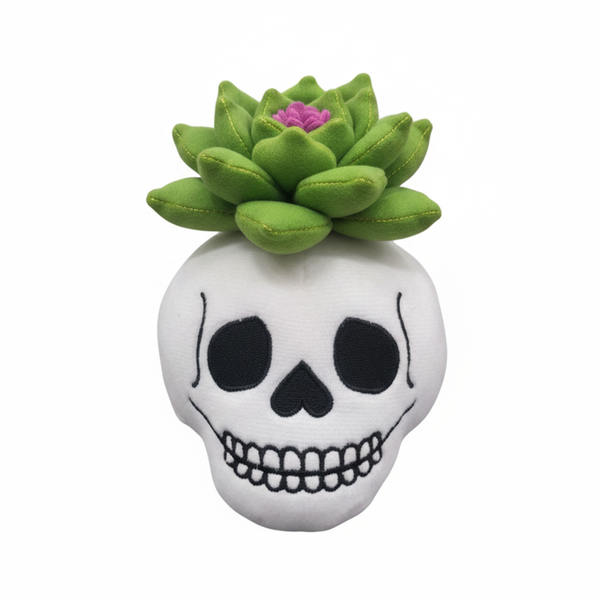White skull-shaped plush toy with green succulent on a white background