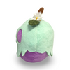 Plush toy resembling a flower with a white petal and green leaves on a white background