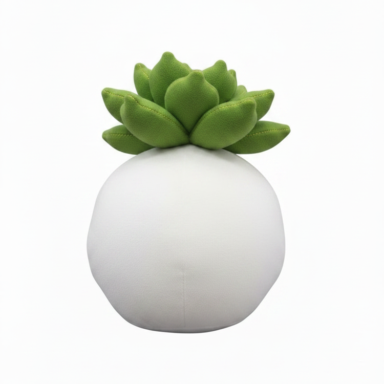 White spherical pillow with green succulent-like top on a white background