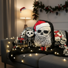 Decorative pillows with skeleton designs and Christmas elements on a couch.