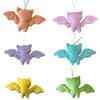 Set of colorful bat-shaped ornaments on a white background