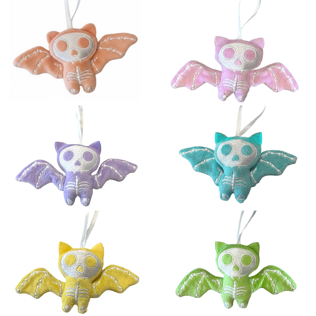 Set of colorful bat-shaped ornaments on a white background