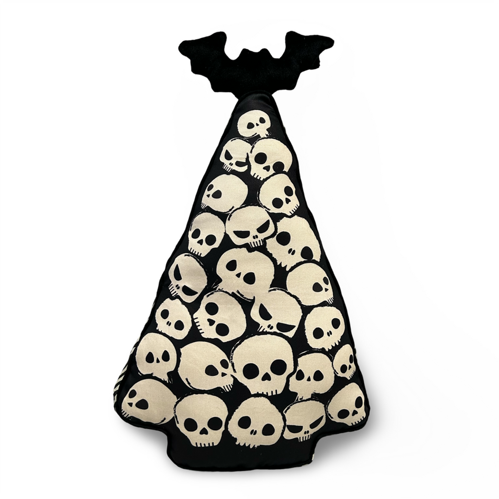 pile of skulls christmas tree with plush bat topper striped sides and polka print back pillow spooky creepmas home decor spooky christmas decor creepy christmas pillows