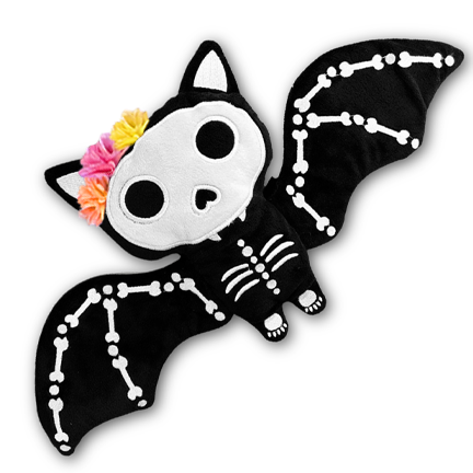 Bat-shaped plush toy with skeleton design and colorful hair bow on a white background