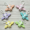 Set of colorful bat-shaped plush toys on a light wooden surface