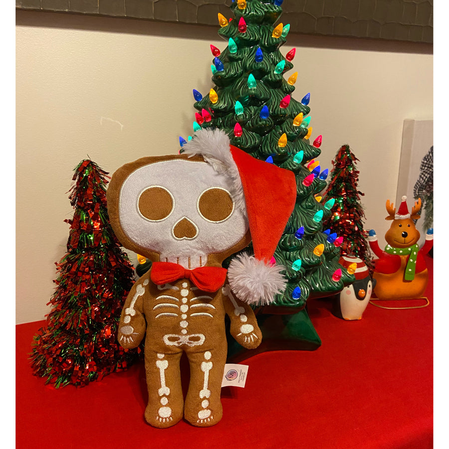 12 inch tall gingerdead skeleton plush in a red santa hat with a red bow tie made in brownminky white embroidery beautiful embroidery high quality plush halloween skeleton bat plushie halloween goth home decor childrens halloween christmas or creepmas skeleton plush toy