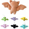 Set of colorful bat-shaped plush toys on a white background
