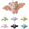 Set of colorful bat-shaped plush toys on a white background
